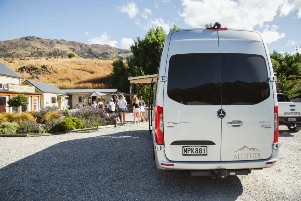 Altitude Tours Mercedes van parked outside a winery in Gibbston Valley.