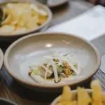 Degustation dishes and wine served during the Milford Sound Business Class cruise
