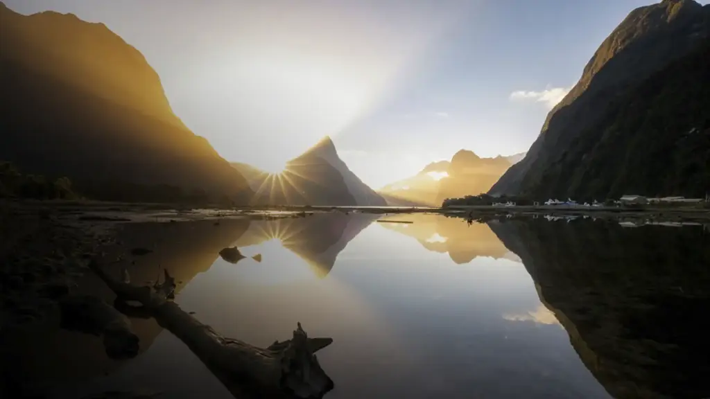 Sunrise over Mitre Peak and Milford Sound reflected in calm fiord water