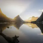 Sunrise over Mitre Peak and Milford Sound reflected in calm fiord water
