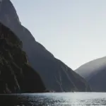 Scenic Milford Sound cruise with sun rays over Mitre Peak in Fiordland National Park